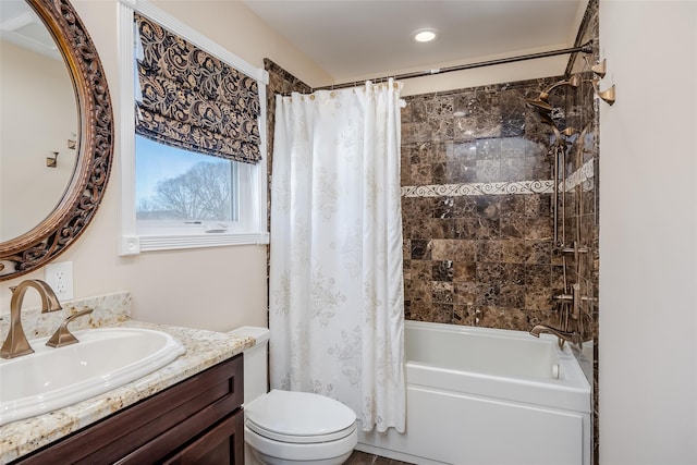 full bathroom featuring shower / bath combo, vanity, and toilet