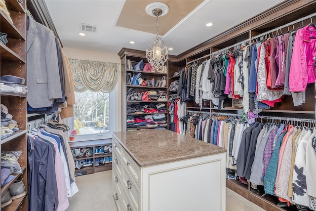 walk in closet with carpet, visible vents, and a chandelier