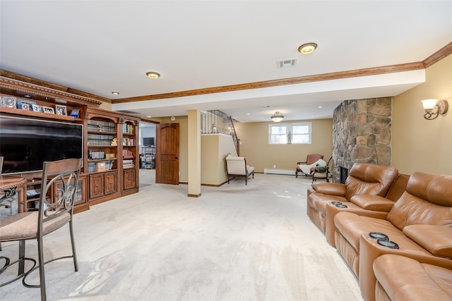 living area with crown molding, light colored carpet, visible vents, a stone fireplace, and baseboards