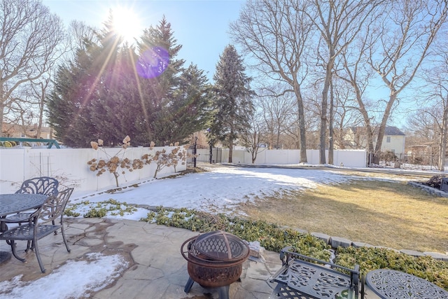 view of yard with a patio area, a fenced backyard, outdoor dining area, and an outdoor fire pit