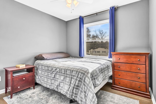 bedroom featuring ceiling fan and baseboards