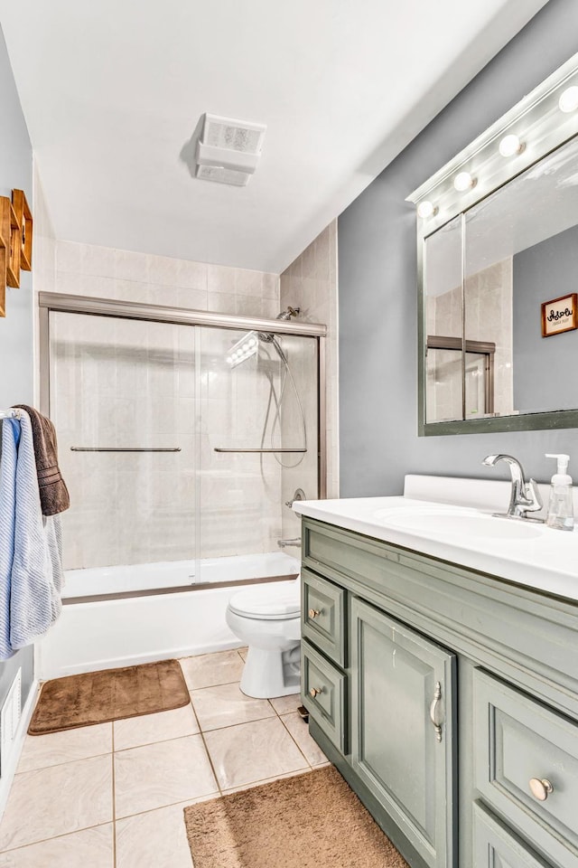 full bath featuring visible vents, toilet, combined bath / shower with glass door, vanity, and tile patterned flooring