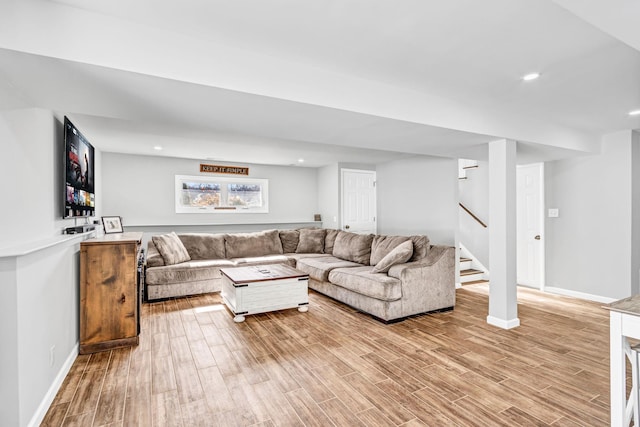 living area featuring stairs, recessed lighting, light wood-type flooring, and baseboards