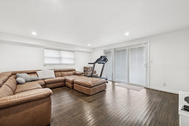 living area featuring visible vents, baseboards, dark wood-type flooring, and recessed lighting