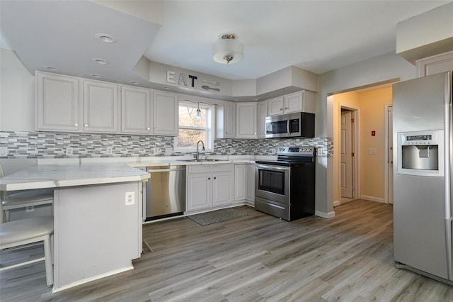 125 Cedar Hill Rd, Wappingers Falls, NY 12590 - kitchen with appliances with stainless steel finishes, a sink, a peninsula, and white cabinets