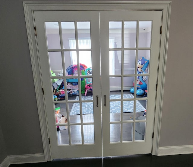 entryway featuring french doors and baseboards