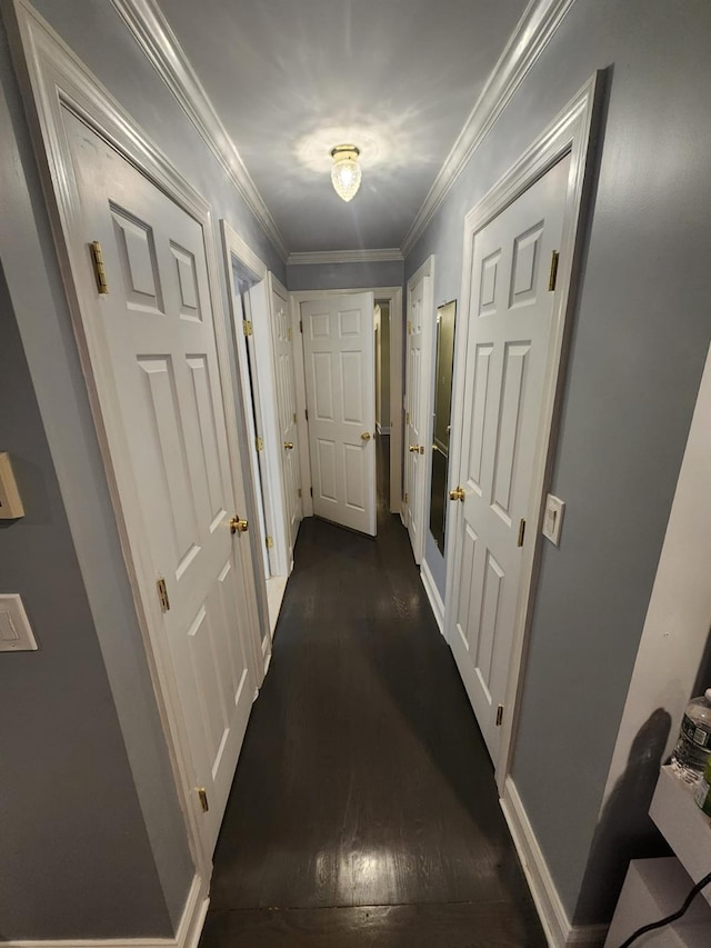 hall with baseboards, dark wood-style flooring, and crown molding