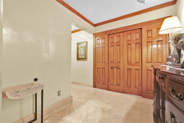 interior space featuring marble finish floor, baseboards, and ornamental molding