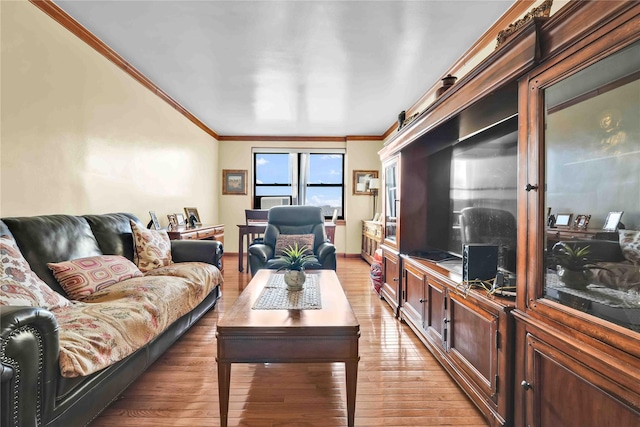 living area with ornamental molding and light wood-style floors