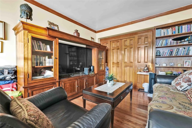 living area featuring crown molding and wood finished floors