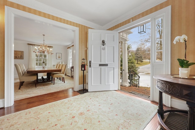 entryway featuring wallpapered walls, ornamental molding, dark wood-style flooring, and baseboards