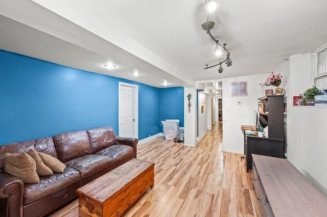 living room with rail lighting and light hardwood / wood-style flooring