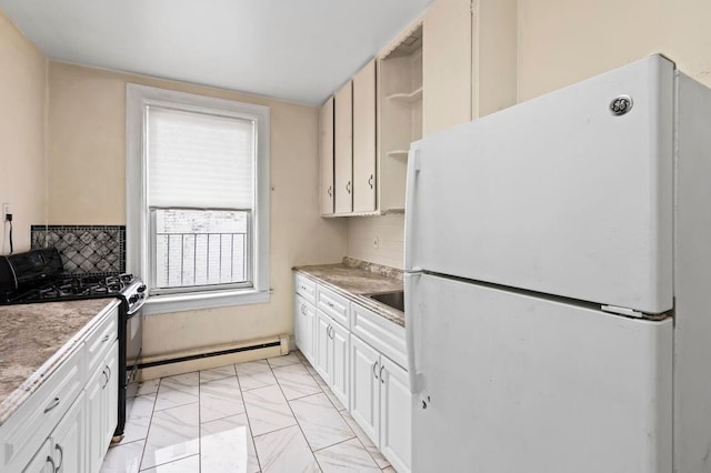 kitchen with white fridge, gas stove, white cabinets, and a baseboard radiator