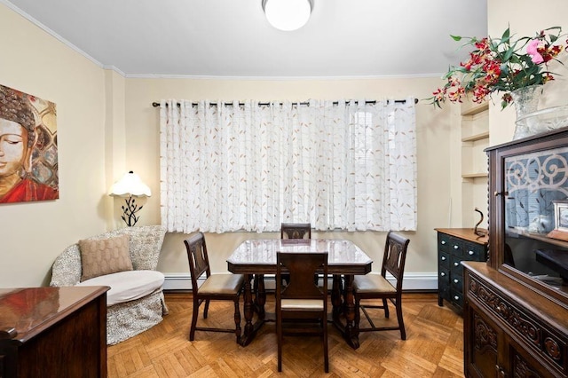 dining area with ornamental molding, light parquet floors, and baseboard heating