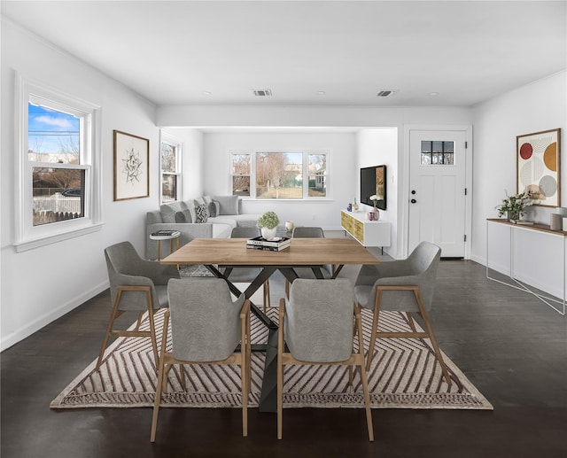 dining area featuring dark hardwood / wood-style flooring and a healthy amount of sunlight