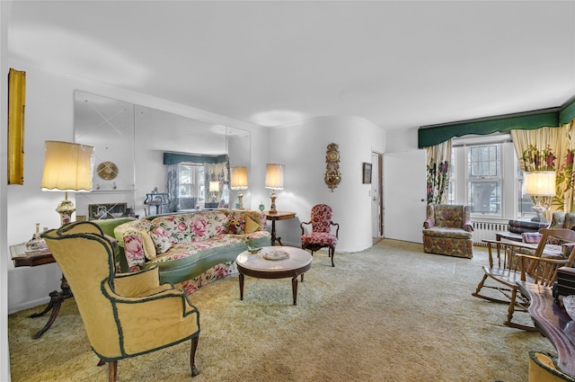 living room with carpet floors, radiator heating unit, and a wealth of natural light