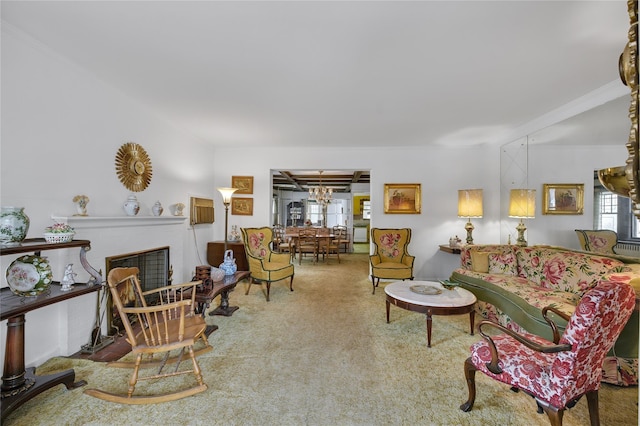 living room featuring an inviting chandelier, carpet, and a fireplace