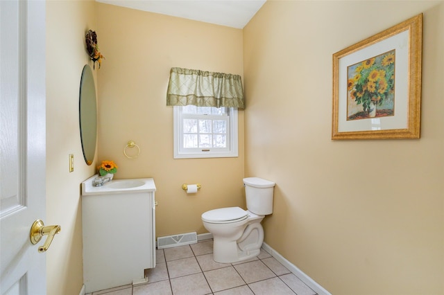 bathroom with tile patterned flooring, toilet, baseboards, vanity, and visible vents