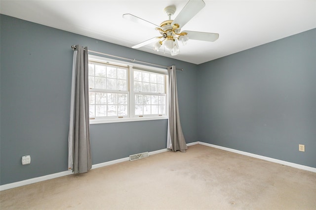 unfurnished room with a ceiling fan, baseboards, carpet floors, and visible vents