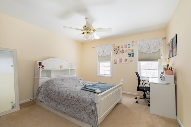 bedroom with baseboards, a ceiling fan, and light colored carpet