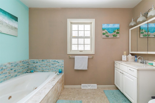 full bathroom featuring baseboards, a jetted tub, vanity, and visible vents