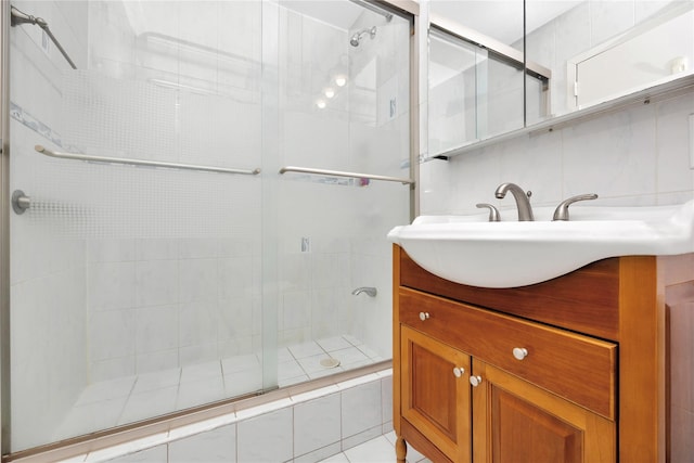 full bath featuring a shower stall, tasteful backsplash, and vanity