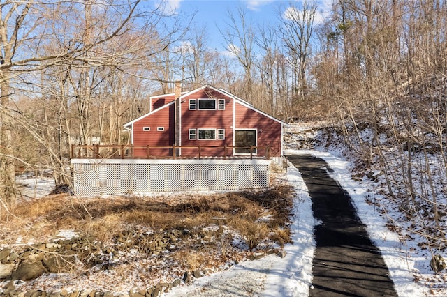 view of snow covered exterior with a deck