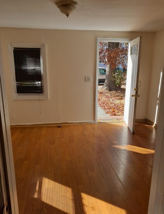 unfurnished room featuring wood-type flooring