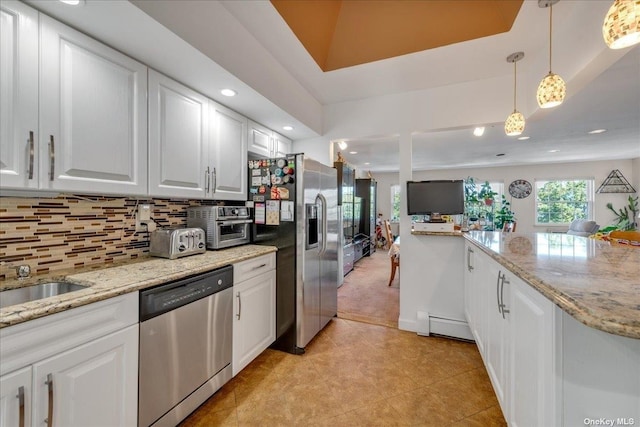 kitchen with pendant lighting, tasteful backsplash, recessed lighting, appliances with stainless steel finishes, and white cabinetry