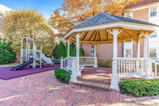 view of patio with playground community and a gazebo