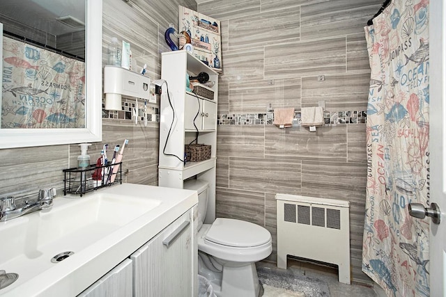 4016 Wilder Ave, Bronx, NY 10466 - full bathroom featuring radiator heating unit, tile walls, vanity, toilet, and tasteful backsplash