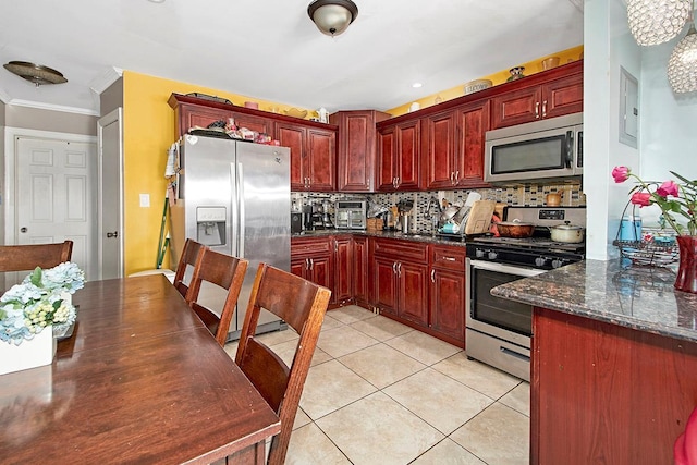 4016 Wilder Ave, Bronx, NY 10466 - kitchen with appliances with stainless steel finishes, reddish brown cabinets, crown molding, decorative backsplash, and light tile patterned floors