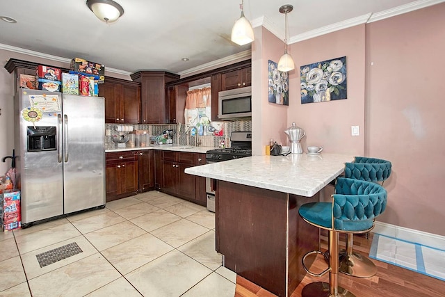 4016 Wilder Ave, Bronx, NY 10466 - kitchen with appliances with stainless steel finishes, a peninsula, crown molding, a breakfast bar area, and tasteful backsplash
