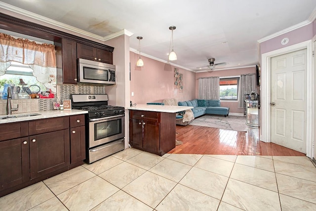 4016 Wilder Ave, Bronx, NY 10466 - kitchen with stainless steel appliances, a sink, open floor plan, a peninsula, and light countertops