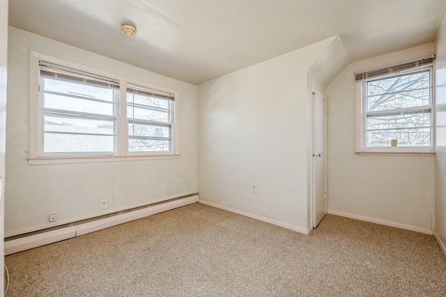 spare room with carpet, a baseboard radiator, and baseboards