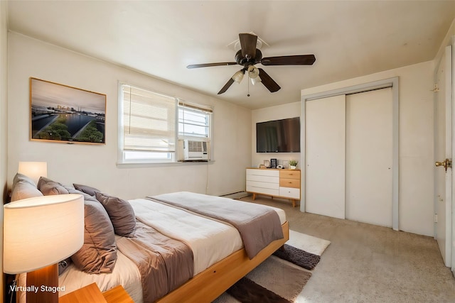 bedroom with a closet, light colored carpet, a baseboard heating unit, a ceiling fan, and cooling unit