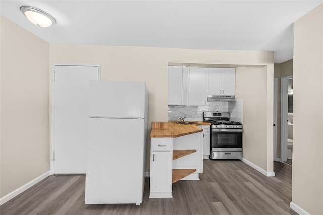 kitchen with freestanding refrigerator, gas stove, white cabinets, wood counters, and under cabinet range hood