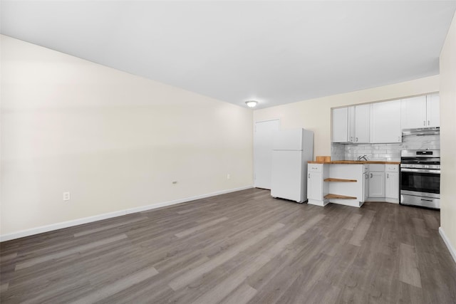 kitchen with white cabinets, gas range, butcher block countertops, open floor plan, and freestanding refrigerator