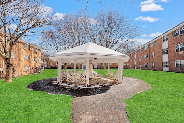 view of property's community with a yard and a gazebo