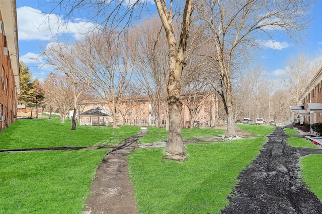 surrounding community with a gazebo and a yard