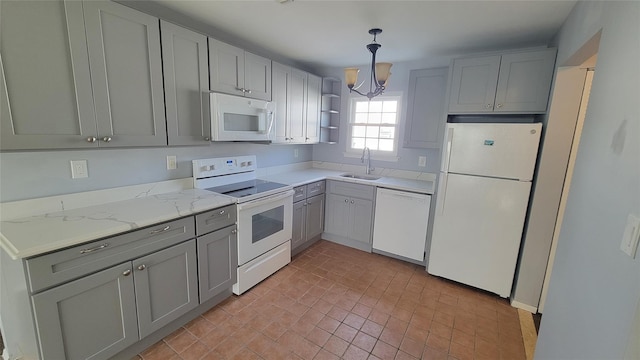 kitchen with white appliances, a sink, light stone countertops, open shelves, and decorative light fixtures