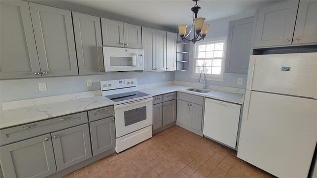 kitchen with white appliances, a sink, gray cabinets, open shelves, and decorative light fixtures