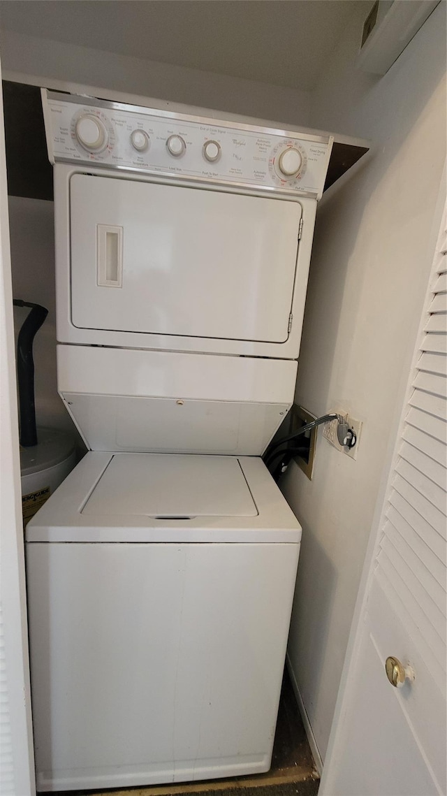 washroom with laundry area and stacked washer / drying machine