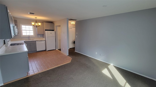 kitchen with light countertops, visible vents, carpet flooring, a sink, and white appliances