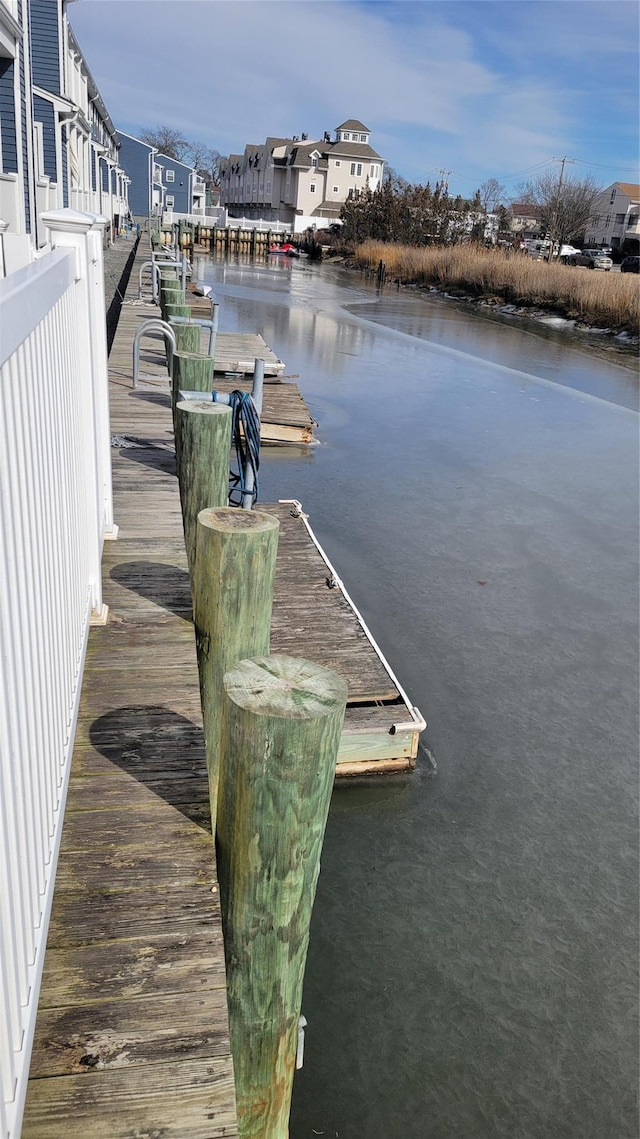 dock area featuring a residential view and a water view