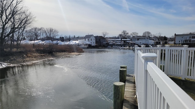 view of dock featuring a water view and a residential view