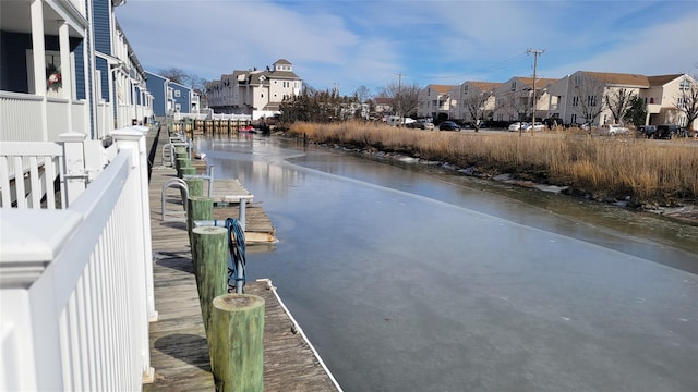 exterior space with a residential view and a floating dock