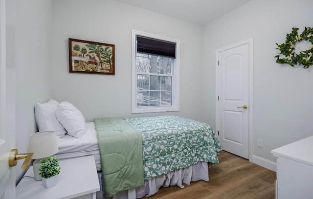 bedroom featuring dark wood finished floors and baseboards