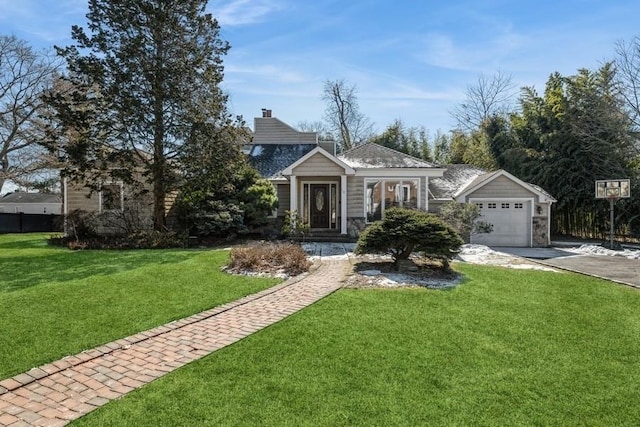 view of front of home featuring driveway, a chimney, and a front yard