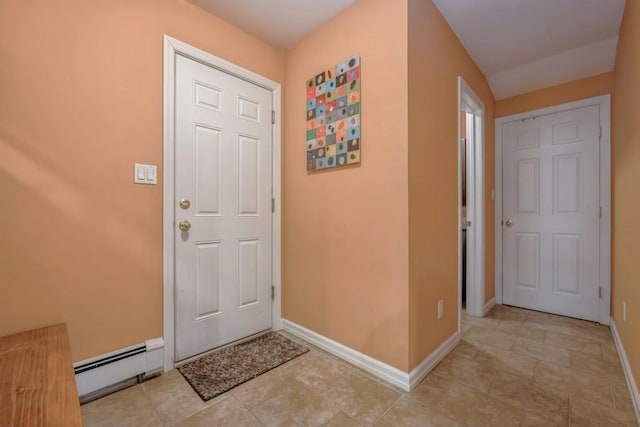 foyer with a baseboard radiator and baseboards